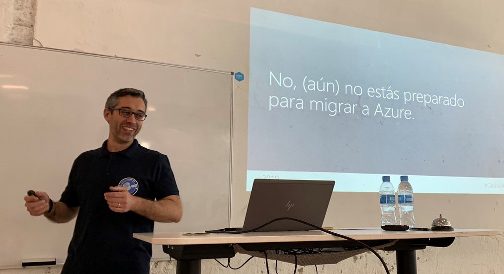 Yo mismo dando la charla del Azure Bootcamp. Se ve la presentación proyectada en la pared, con el título de la charla.